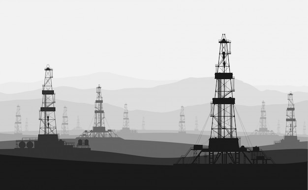 Vector oil rigs at large oilfield over mountain range.