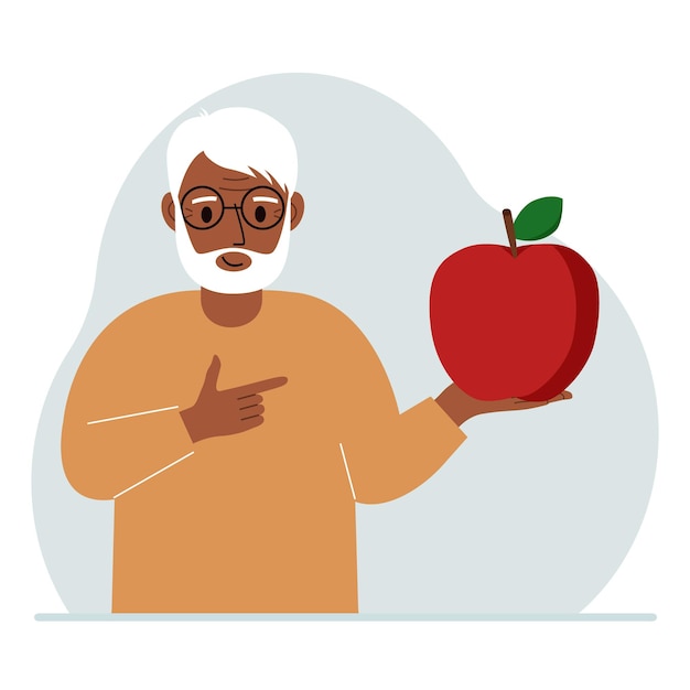 Un vecchio tiene in mano una mela fresca e rossa l'uomo mangia una mela concetto di cibo sano