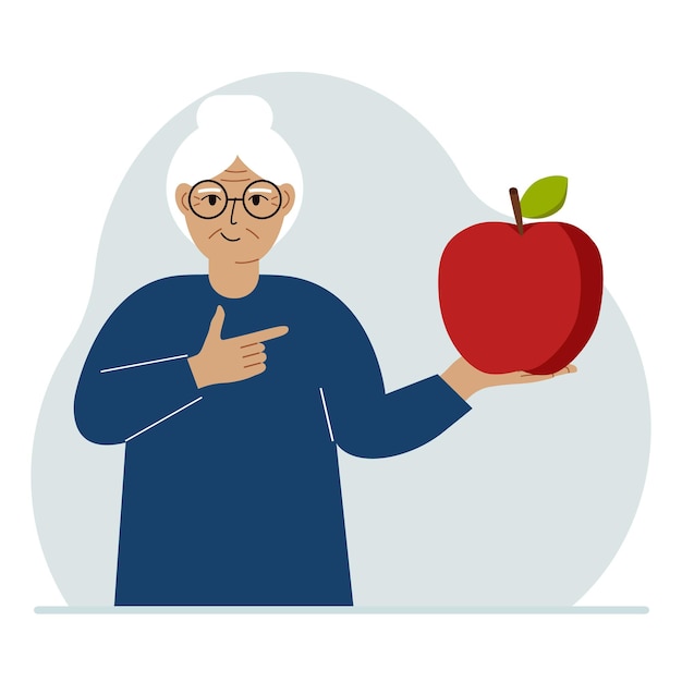 A old woman holds a fresh and red apple in his hand Woman eats an apple Healthy food concept