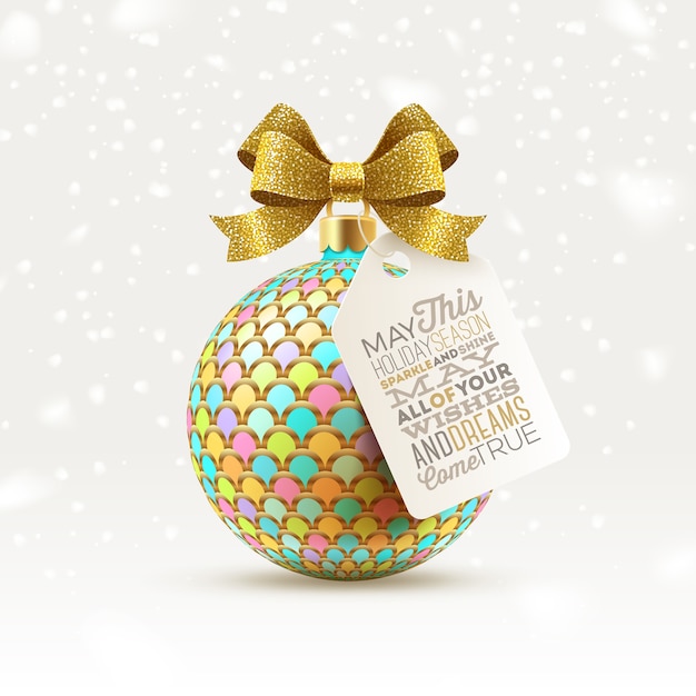 Sfera di natale decorata con fiocco glitter oro e tag con saluto