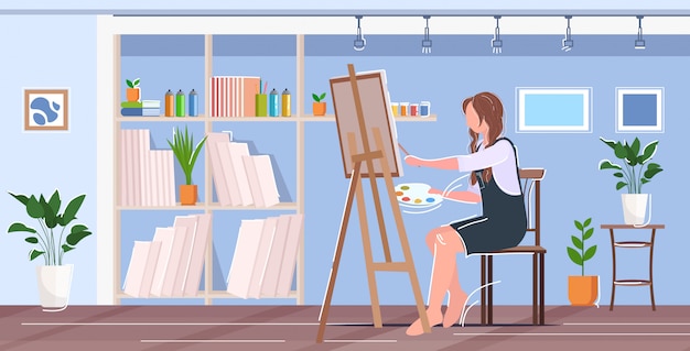 Painter using paintbrush and palette woman artist sitting in front of easel art concept modern workshop studio interior horizontal