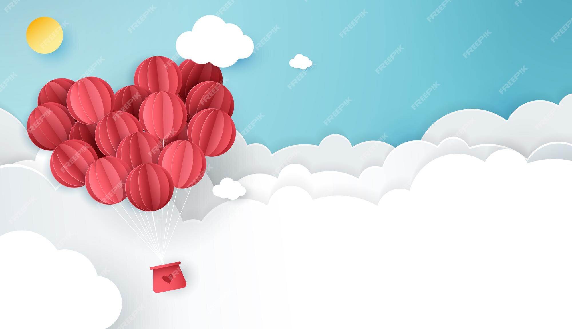 Palloncini a forma di cuore rosso che galleggiano nel cielo