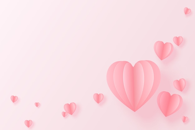 Elementi di carta a forma di cuore che volano su sfondo rosa