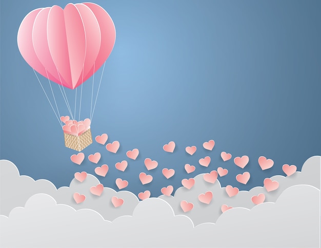 Paper heart in wooden basket bonded with pink balloon on the sky