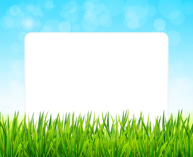 Лист бумаги на фоне зеленой травы и голубого неба