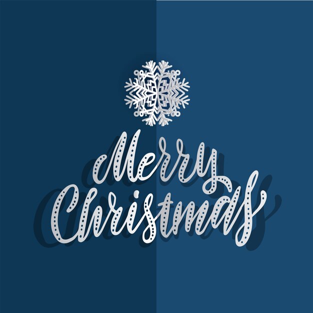 papieren Kerst sneeuwvlokken op een blauwe achtergrond met hand getrokken borstel belettering Merry Christmas