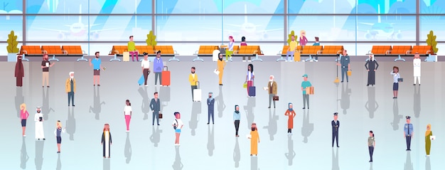 people in airport travelers with baggage walking through 