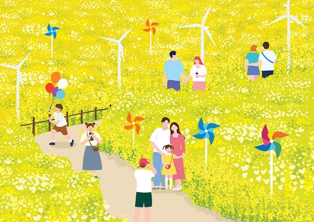 People enjoying a festival and a walk in a wide field of yellow rape flowers