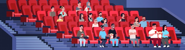 people group watching movie sitting in cinema with popcorn and cola mix race men women having fun laughing at new comedy flat full length horizontal