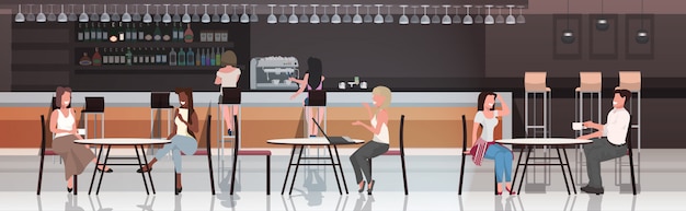 people sitting at cafe tables drinking coffee discussing during meeting