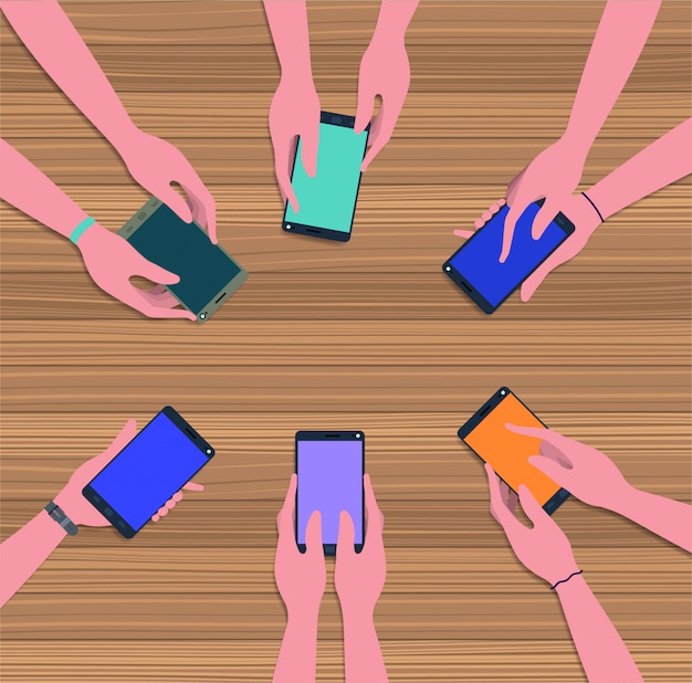 people using smartphones in the table