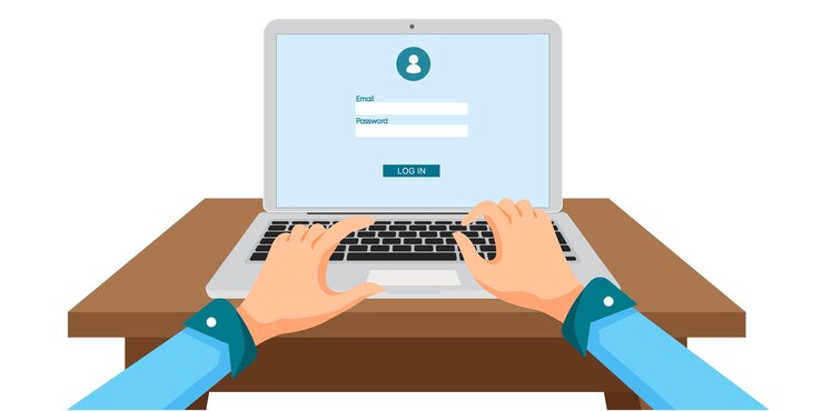 Person typing login credentials on a laptop on a wooden desk