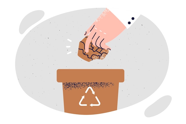 Persoonshand gooit papier in emmer met recyclingsymbool dat de schadelijke impact op het milieu wil verminderen Concept van het bestrijden van co2-uitstoot door papier- en plastic afval te recyclen