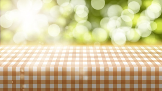 Picnic table covered with tablecloth on blurred background