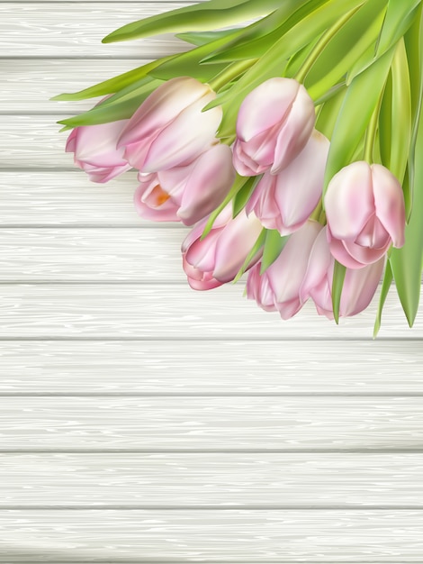 Pink Tulips over wooden table.