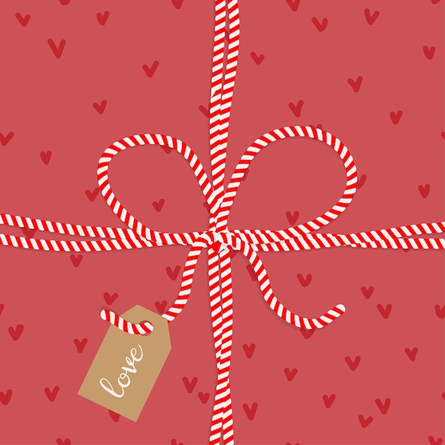 Postcard gift tied with a red white candy cane ribbon with hearts Concept for Valentines day love