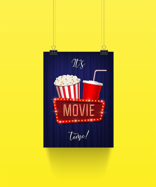 Poster hanging on paper clips with pop corn bucket and soda cup with movie sign