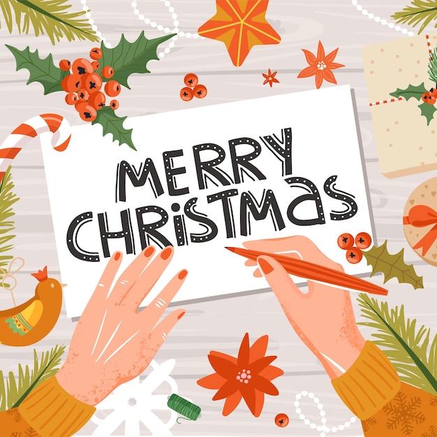 新年の準備女性の手はクリスマスカードに署名します