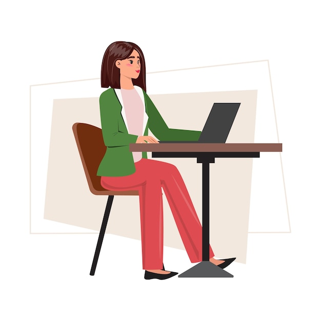 Pretty young woman in a green suit sitting at the desk working seamlessly from her laptop