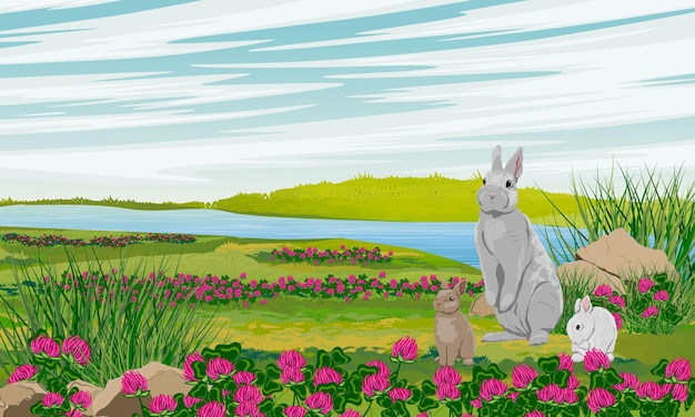 A rabbit and two bunnies are sitting in a summer meadow with clover flowers and grass on the bank of