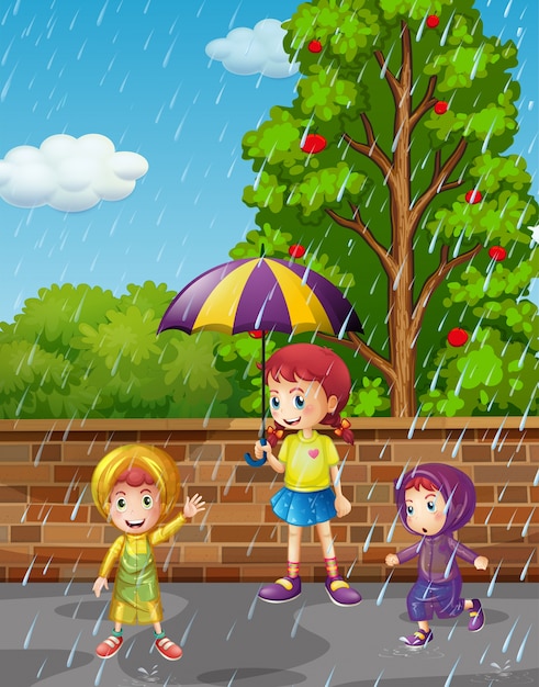 雨の中で3人の子供がいる雨季