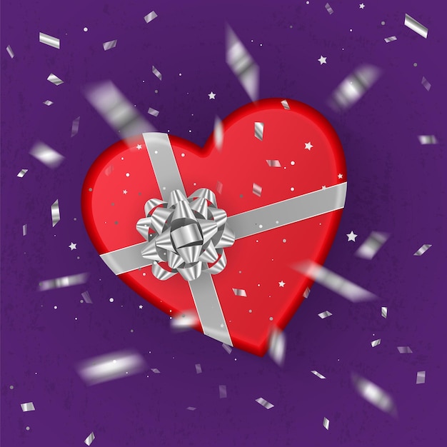 A realistic red gift box with shape of heart decorated with a silver bow, top view.