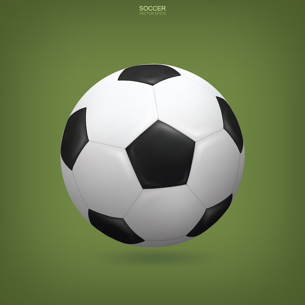 Realistic soccer ball on green background.