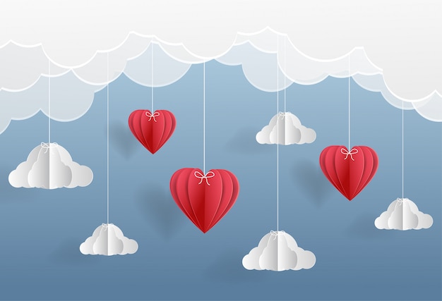 Red heart balloons and fluffy clouds