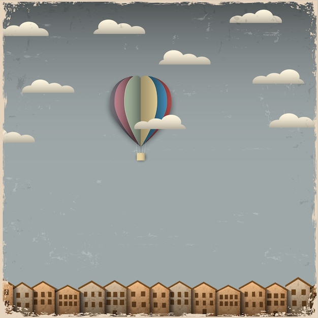 Retro hot air balloon and town from paper