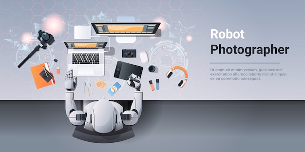 Robot photographer sitting at workplace robotic designer