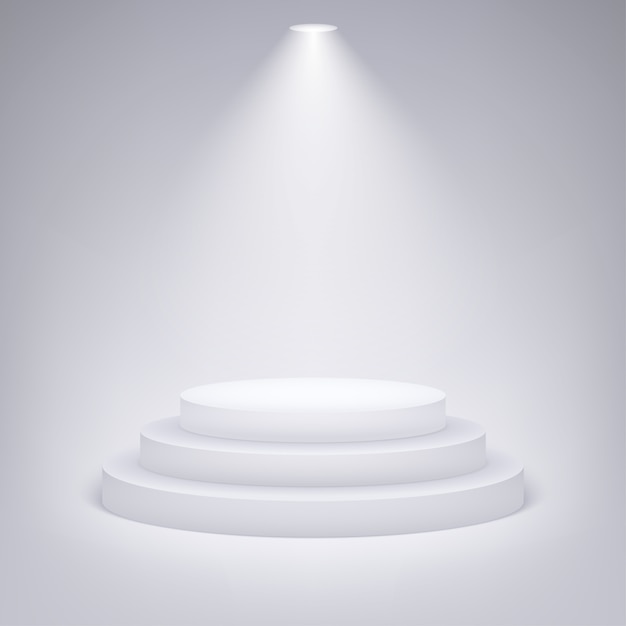 Round podium illuminated by spotlight on gray background.