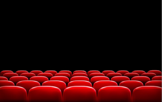 File di sedili rossi del cinema o del teatro davanti allo schermo nero con spazio di testo di esempio.
