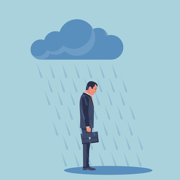 Sad businessman standing in the rain