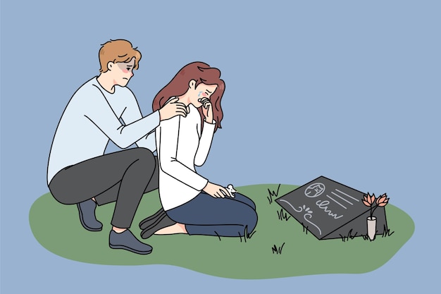 Sad couple crying at pet gravestone