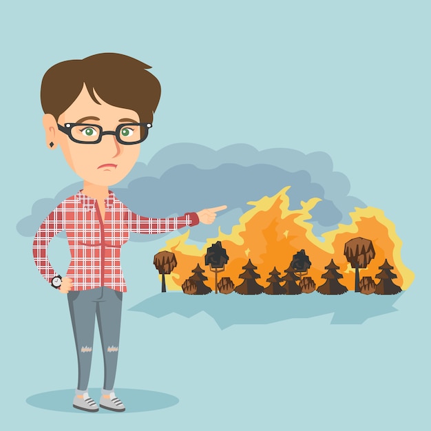 Sad woman pointing to wildfire.