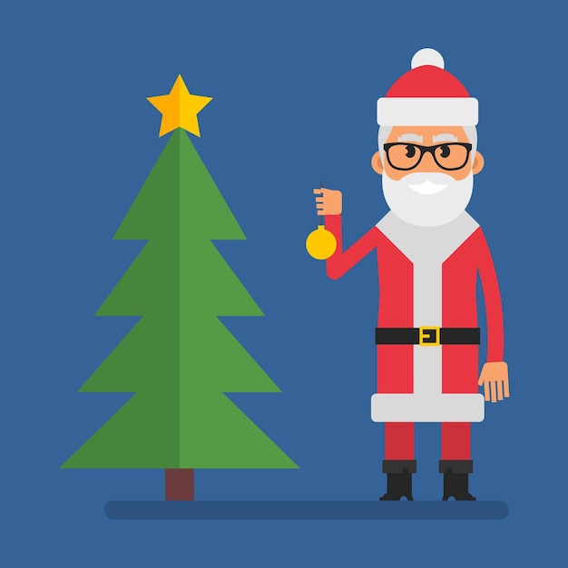 산타는 크리스마스 트리 근처에 서 있고 크리스마스 트리 장난감을 들고 있다