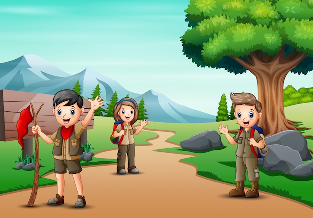 Scene with many kids in scout uniform hiking in the park