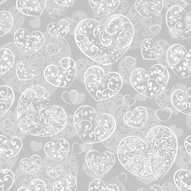 Seamless pattern of big and small hearts with curls white on gray