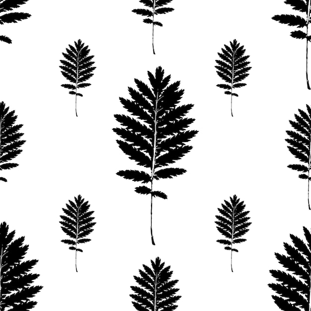 Seamless vector pattern with black leaves of different sizes on a white background