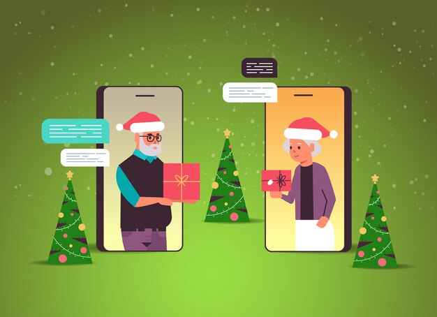Senior paar in santa hoeden met behulp van chatten app sociaal netwerk chat bubble communicatieconcept