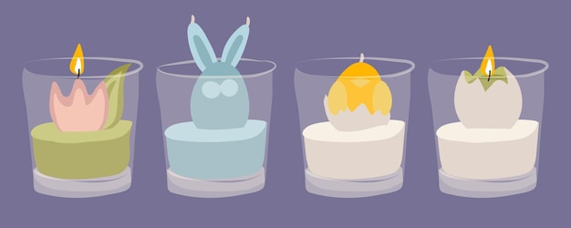 A set of Easter candles with colored elements inside a glass cup A chicken a flower a hare