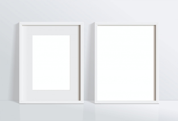 白い壁に掛かっている最小限の空の垂直の白いフレーム画像を設定します。イラストを分離します。