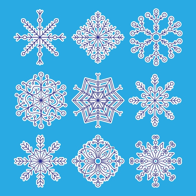 Набор из девяти снежинок в стиле вырезанной бумаги на синем фоне