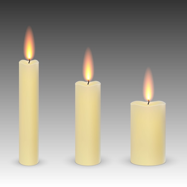 Set of realistic paraffin burning candles isolated