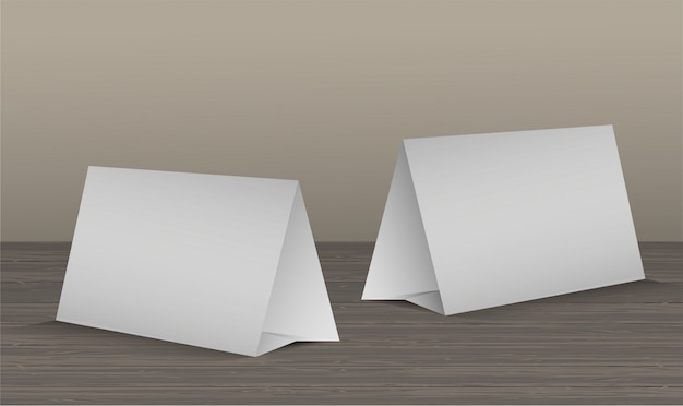 Set of two blank table tent cards on wooden table realistic  