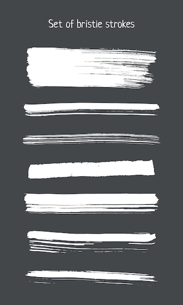 Vector a set of white bristle strokes on a dark gray background. vector design elements. white isolated on a dark background