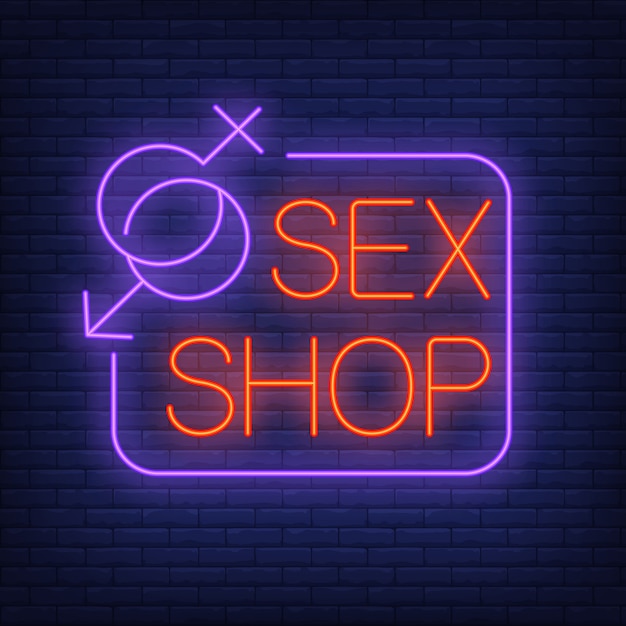 Sex shop neon sign. gender symbols with frame on brick wall.