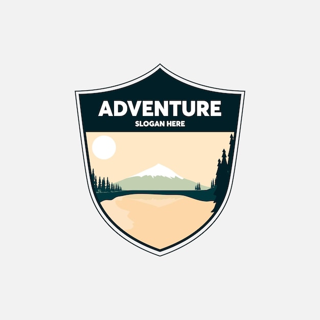 A shield with a mountain and a logo for adventure.