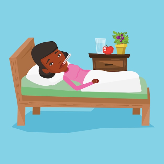 sick woman with thermometer laying in bed.