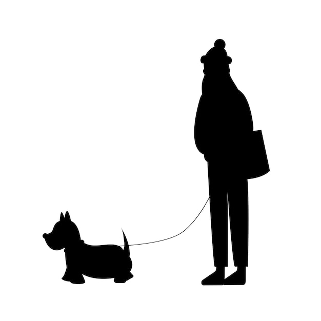 Silhouet van een vrouw die in de winter met een hond loopt